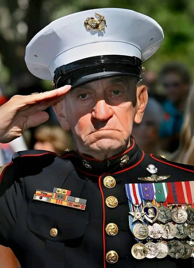 This image shows a veteran in full uniform saluting with pride. His hat carries the Marine Corps emblem. His jacket holds medals and ribbons that show courage, sacrifice, and service. His solemn expression reflects the resilience and honor of those who defend freedom.